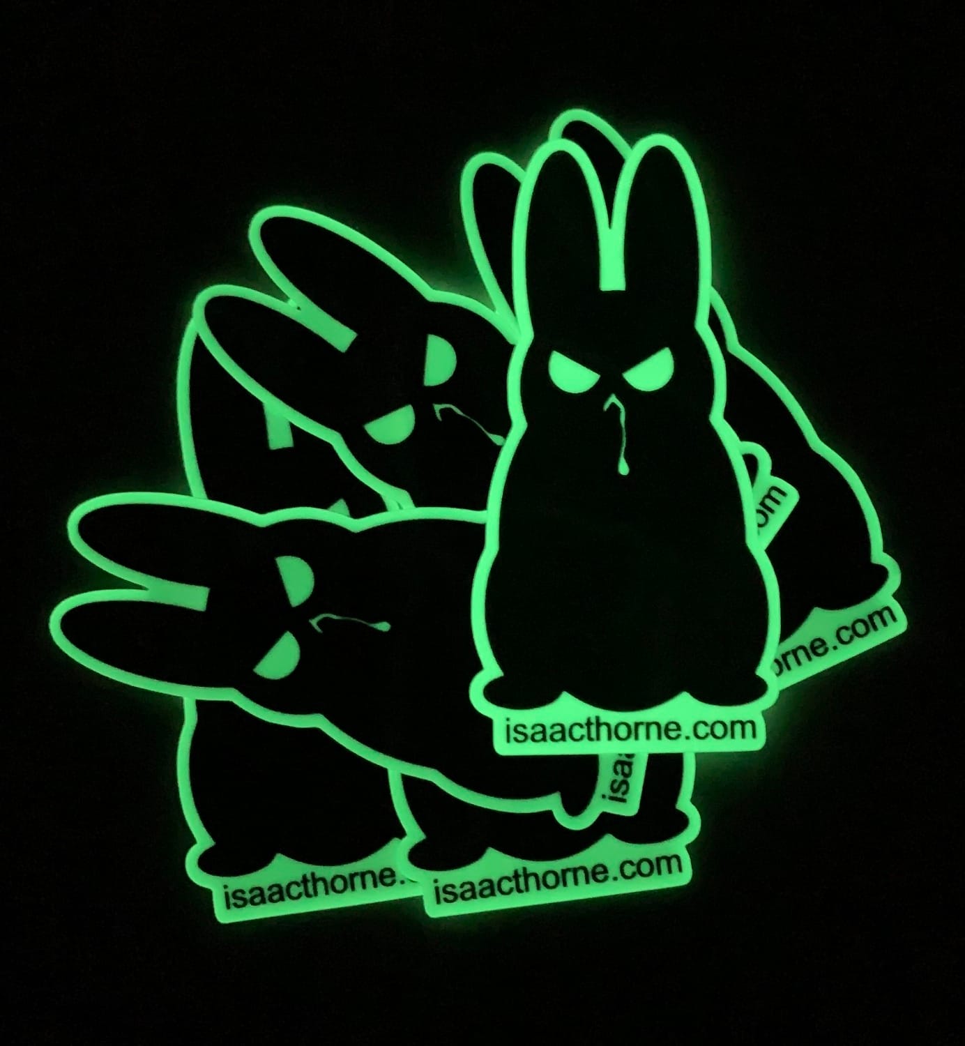 A stack of evil bunny stickers glowing in the dark.